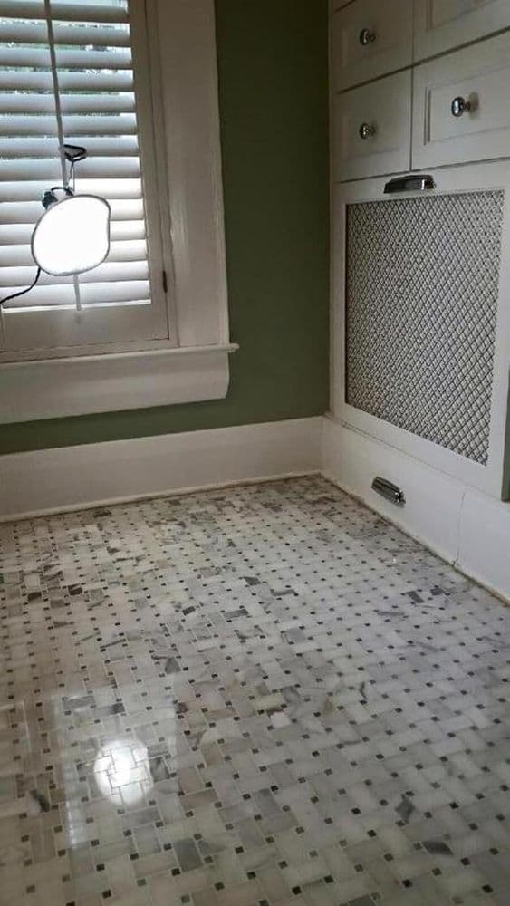 Marble basketweave mosaic bathroom floor with dark accent dots after polishing